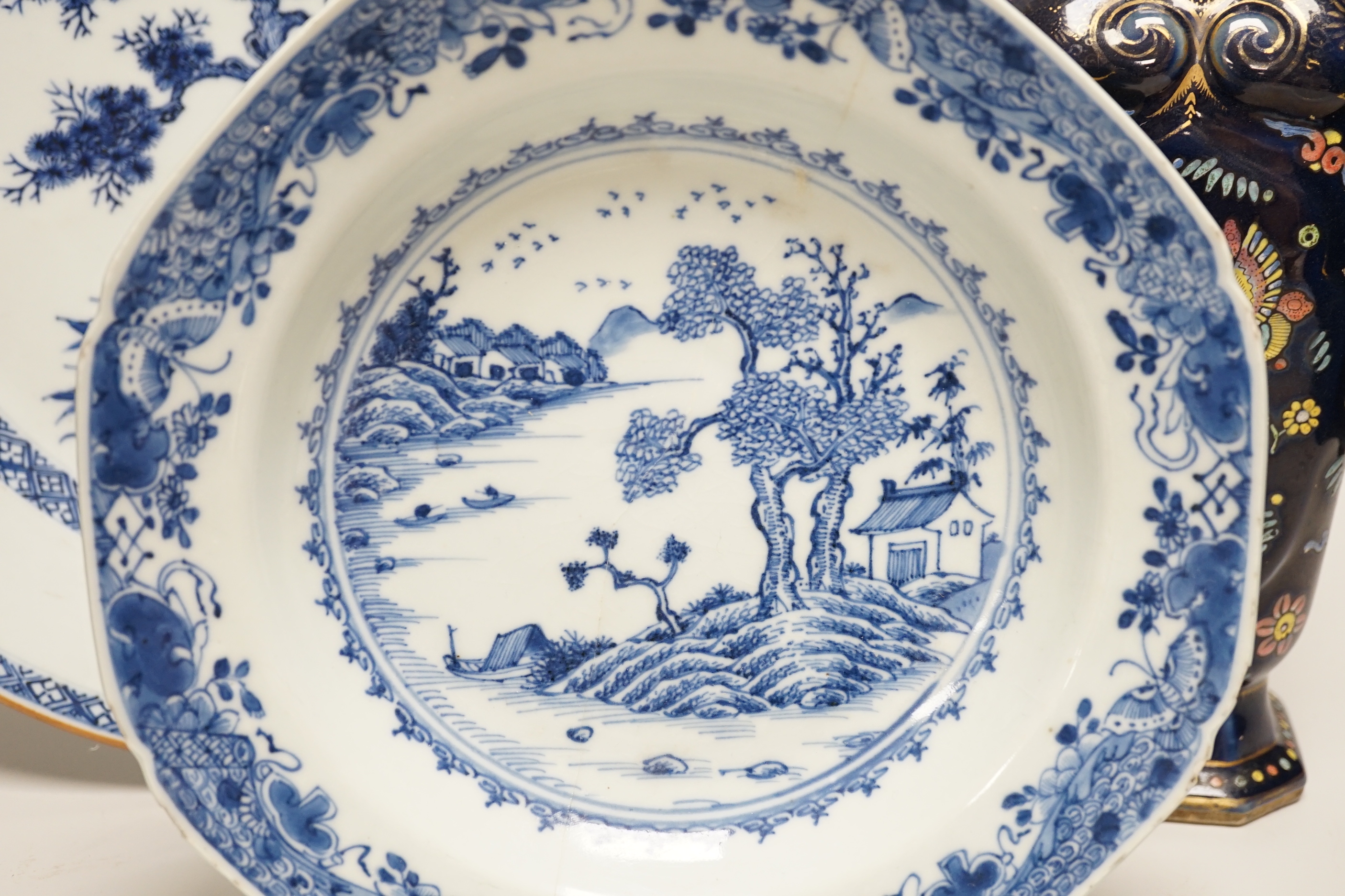 An 18th century Chinese export blue and white charger, a similar soup bowl and a late 19th century enamelled blue ground vase, 32cm